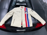 Beige jacket with red, white, and blue stripes draped over a car's rear window.